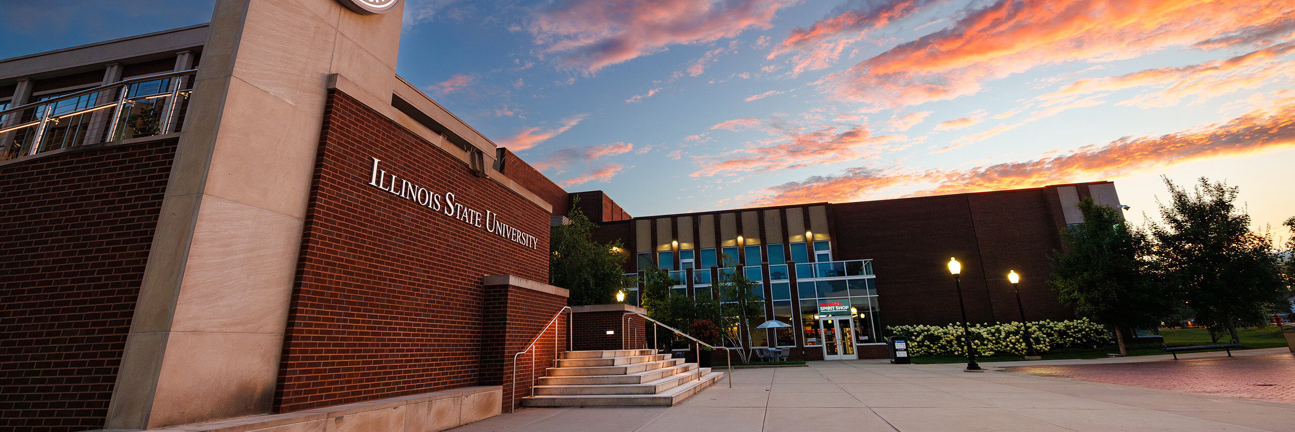 Illinois State University building at sunset with vibrant sky.