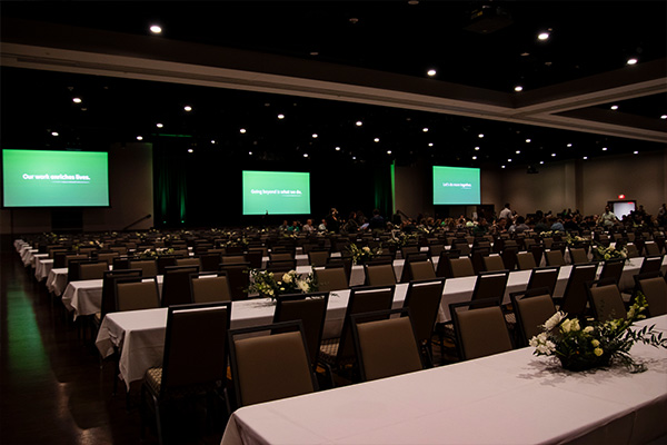 rows of rectangular tables facing video screens