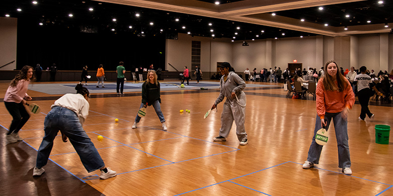Students play pickle ball at an event in the Bone.